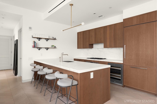 85 Jay St Unit 20Ffront, New York City, NY 11201 - kitchen with wine cooler, a sink, a breakfast bar area, modern cabinets, and light countertops