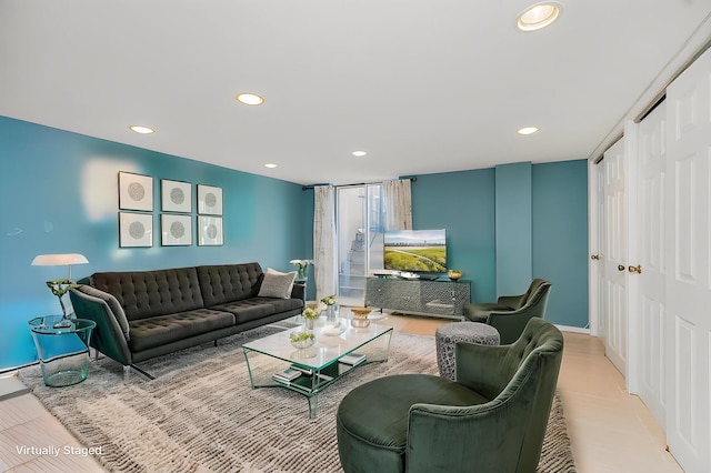 living area featuring recessed lighting and baseboards