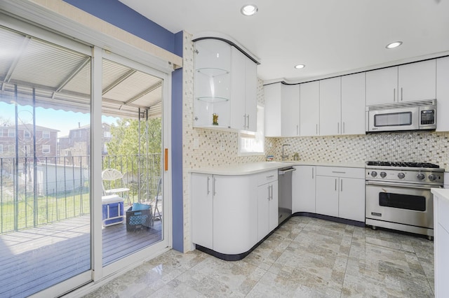 kitchen featuring appliances with stainless steel finishes, tasteful backsplash, light countertops, white cabinets, and recessed lighting