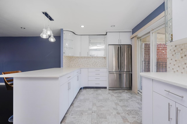 kitchen featuring high quality fridge, decorative backsplash, a peninsula, white cabinets, and recessed lighting
