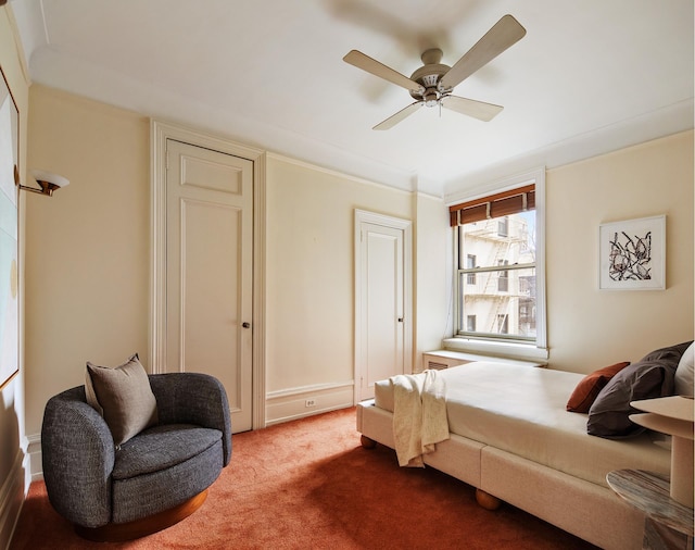 carpeted bedroom with crown molding and a ceiling fan