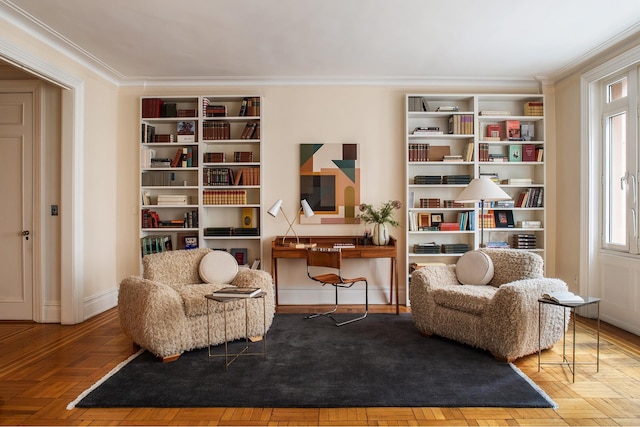 living area with crown molding and baseboards