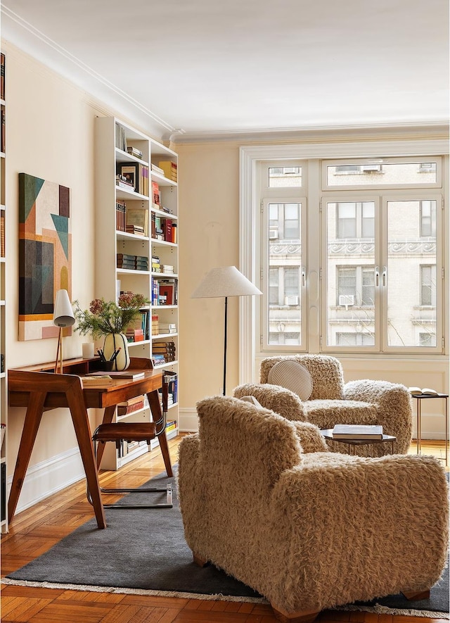 sitting room with a healthy amount of sunlight and ornamental molding