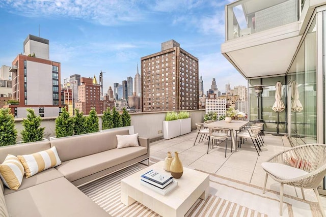 view of patio with a view of city, outdoor dining area, and outdoor lounge area