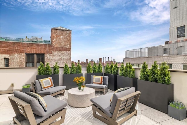 view of patio / terrace featuring an outdoor hangout area and a city view