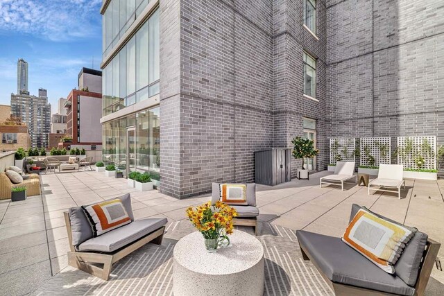view of patio with a view of city and an outdoor living space