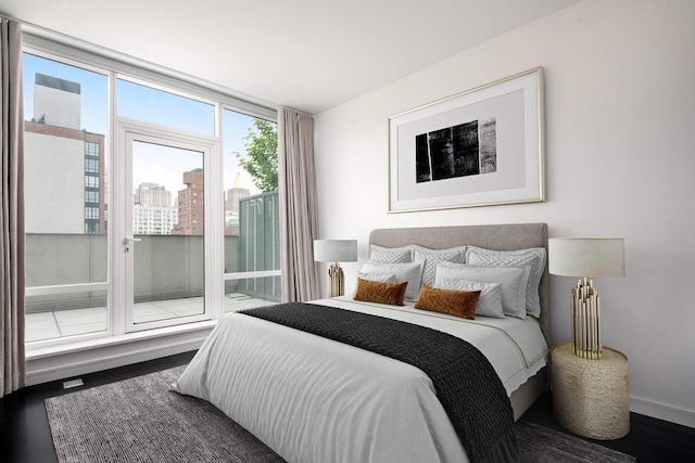 bedroom with baseboards and wood finished floors