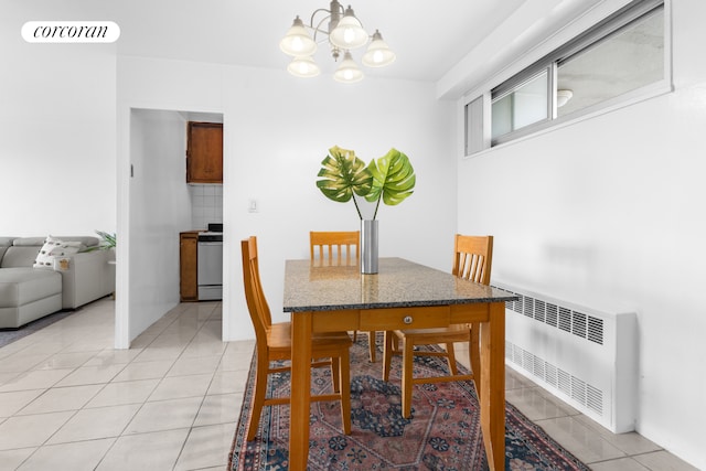 185 Park Row Unit 17F, New York City, NY 10038 - dining room featuring radiator, a chandelier, and light tile patterned flooring