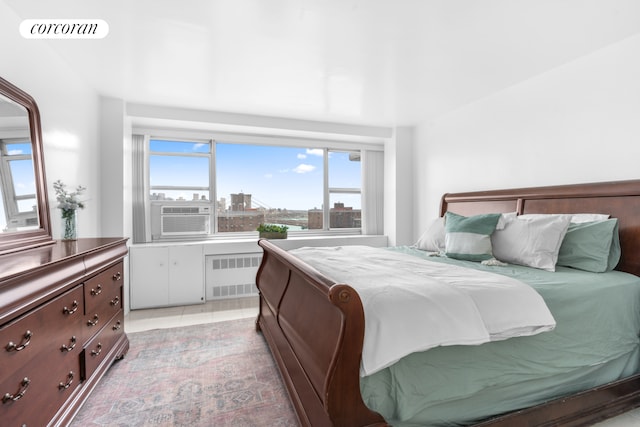 185 Park Row Unit 17F, New York City, NY 10038 - bedroom featuring radiator heating unit, cooling unit, and a view of city