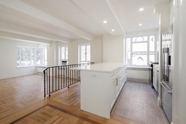 20 E 35th St Unit 4-A, New York City, NY 10016 - kitchen featuring radiator, white cabinetry, light countertops, stainless steel appliances, and recessed lighting