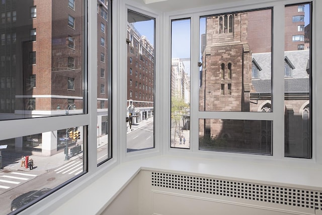doorway to outside featuring a city view and radiator