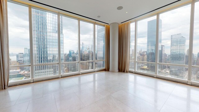 15 Hudson Yards Unit 31A, New York City, NY 10001 - tiled spare room featuring a view of skyline and expansive windows
