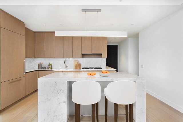 15 Hudson Yards Unit 31A, New York City, NY 10001 - kitchen featuring backsplash, modern cabinets, a center island, light wood-type flooring, and recessed lighting