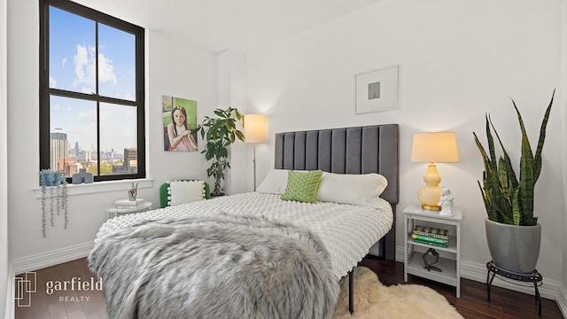 bedroom featuring baseboards and wood finished floors