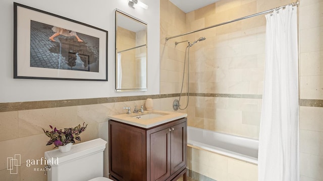 1 Hanson Pl Unit 16-F, New York City, NY 11217 - bathroom featuring tile walls, tiled shower / bath, vanity, and toilet