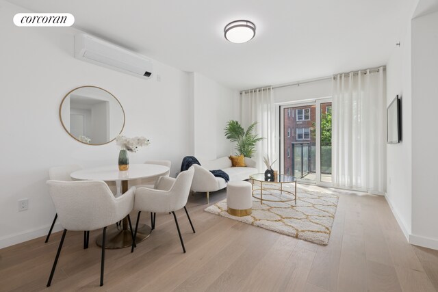 428 E 9th St Unit 411, New York City, NY 11218 - dining area with wood finished floors, baseboards, and a wall mounted AC
