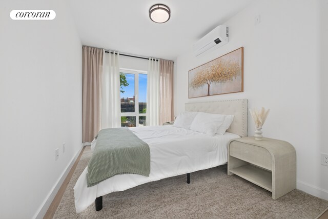 428 E 9th St Unit 411, New York City, NY 11218 - bedroom with a wall mounted AC, baseboards, and carpet
