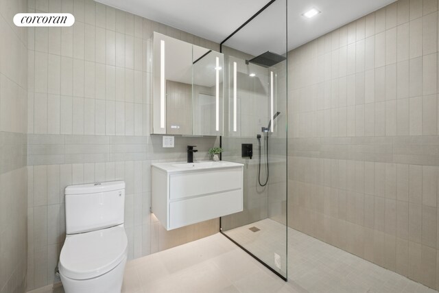 428 E 9th St Unit 411, New York City, NY 11218 - bathroom with tile walls, vanity, walk in shower, and toilet