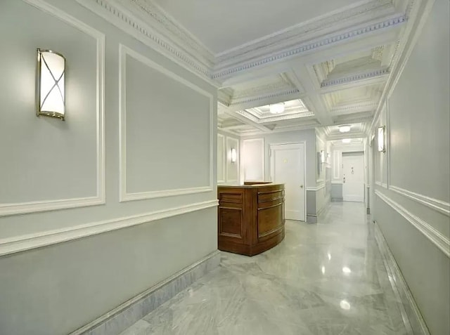 120 W 58th St Unit 7B, New York City, NY 10019 - hall featuring light marble finish floors, coffered ceiling, crown molding, a decorative wall, and beam ceiling