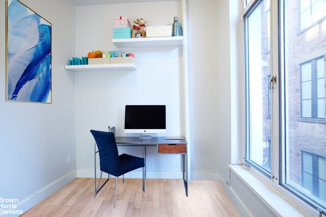 home office featuring baseboards and wood finished floors