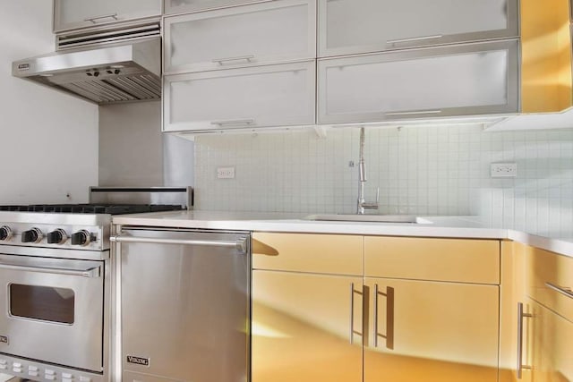 kitchen with light countertops, decorative backsplash, under cabinet range hood, and stainless steel appliances