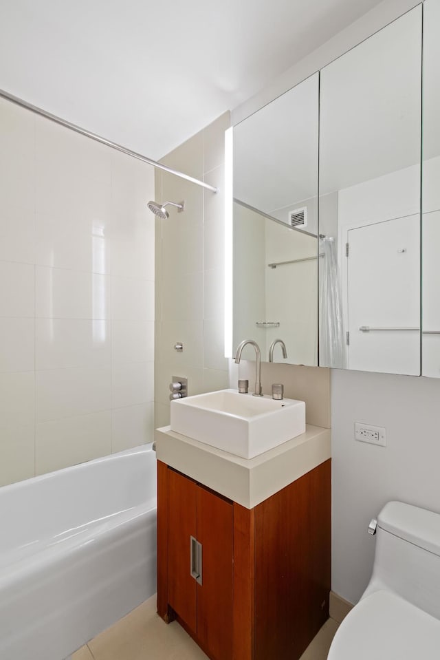 bathroom featuring visible vents, shower / bathtub combination with curtain, toilet, and vanity