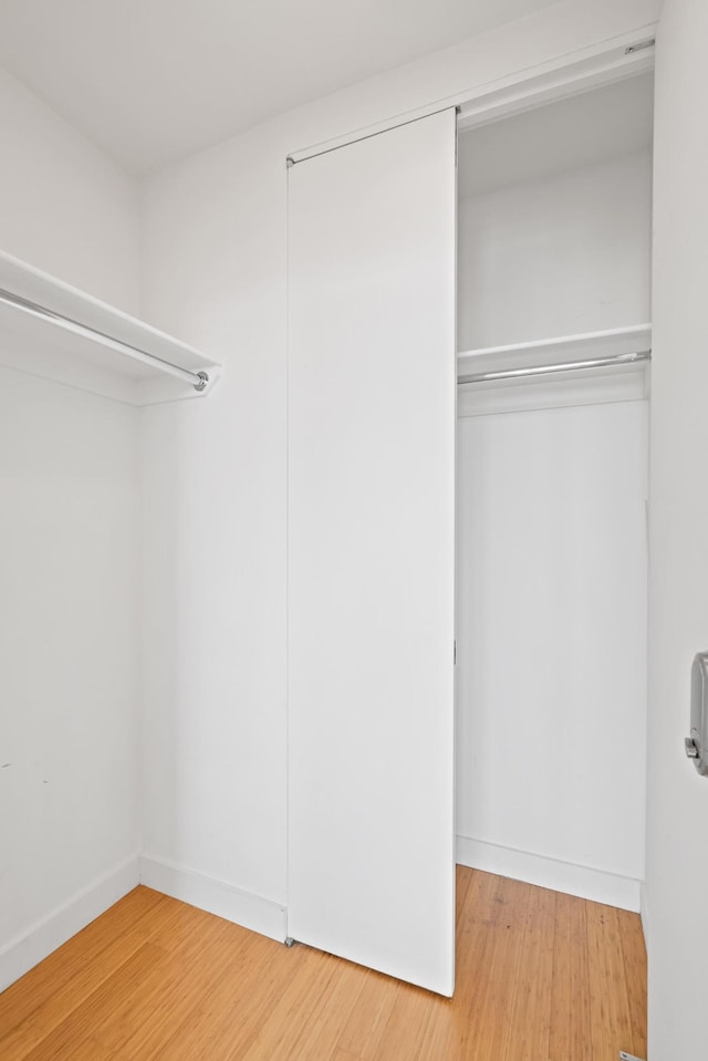 walk in closet featuring light wood finished floors