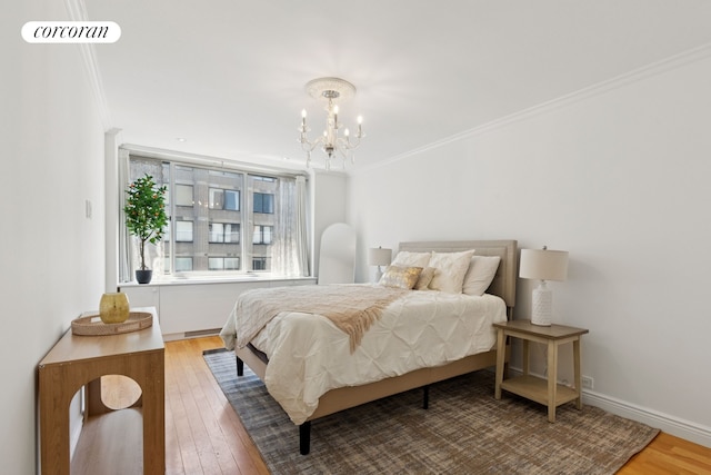 61 W 62nd St Unit 27G, New York City, NY 10023 - bedroom with crown molding, hardwood / wood-style floors, a chandelier, and baseboards