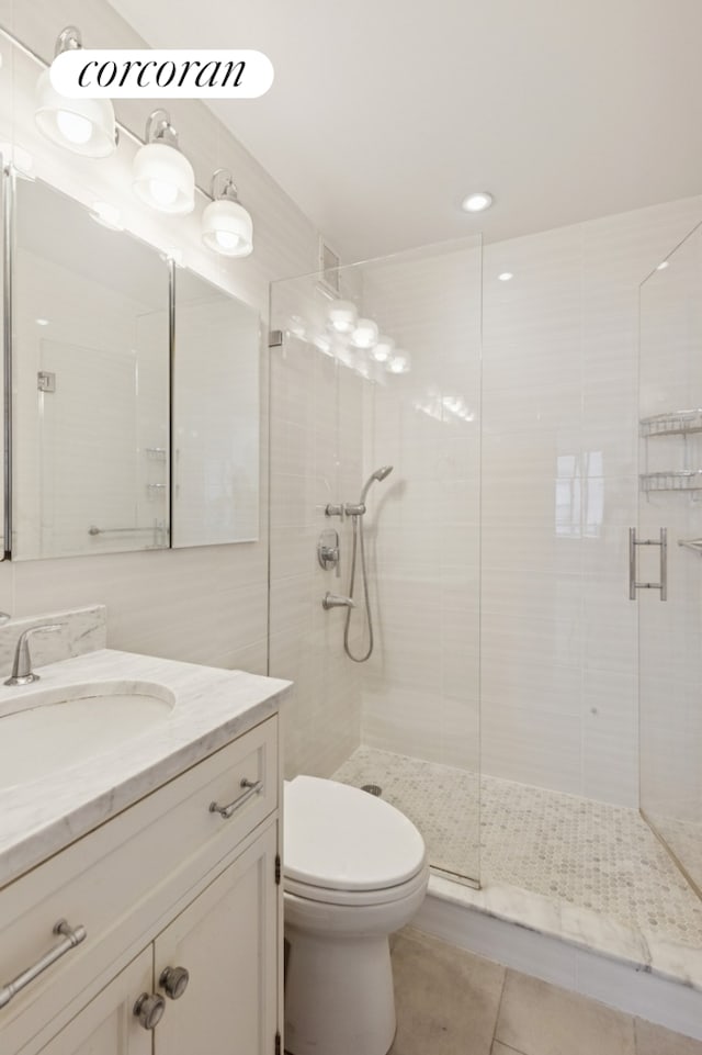 61 W 62nd St Unit 27G, New York City, NY 10023 - bathroom featuring a shower stall, vanity, tile patterned flooring, and toilet