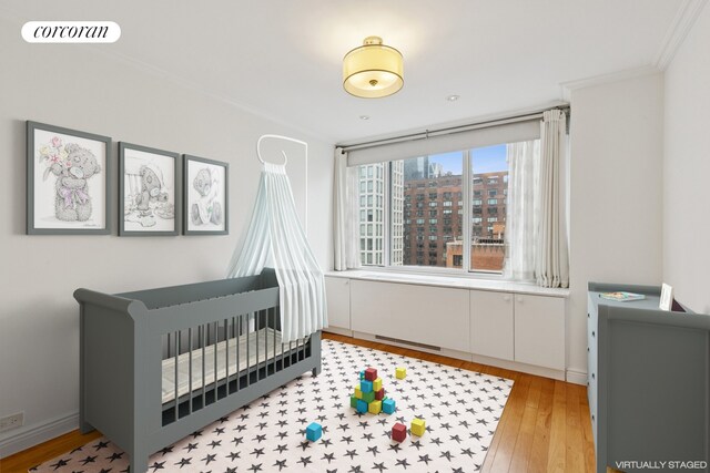 61 W 62nd St Unit 27G, New York City, NY 10023 - bedroom with light wood-style flooring and crown molding