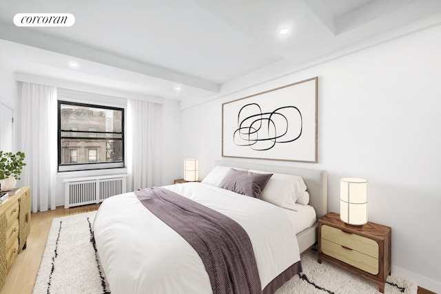 171 W 79th St Unit 56, New York City, NY 10024 - bedroom featuring radiator heating unit, beam ceiling, wood finished floors, and recessed lighting
