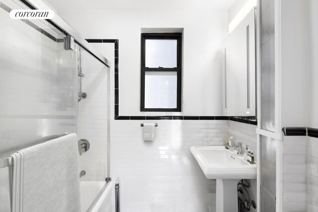 171 W 79th St Unit 56, New York City, NY 10024 - bathroom featuring enclosed tub / shower combo and tile walls