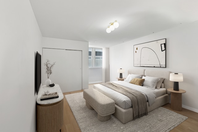 bedroom with wood finished floors and baseboards