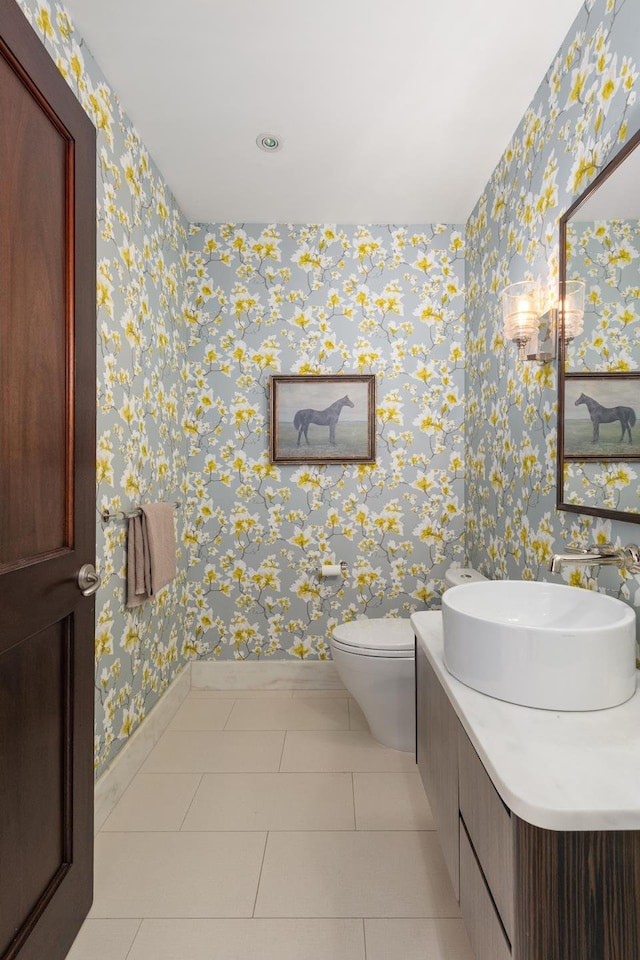 bathroom with tile patterned floors, vanity, toilet, and baseboards