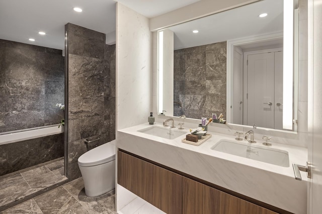 full bathroom with toilet, recessed lighting, double vanity, tile walls, and a bath