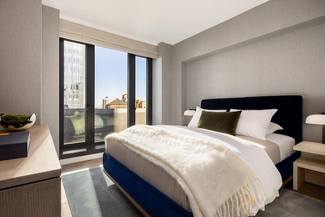 bedroom featuring wood finished floors and access to outside