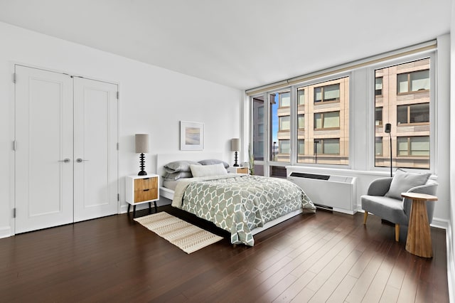 bedroom featuring radiator and dark wood-style floors