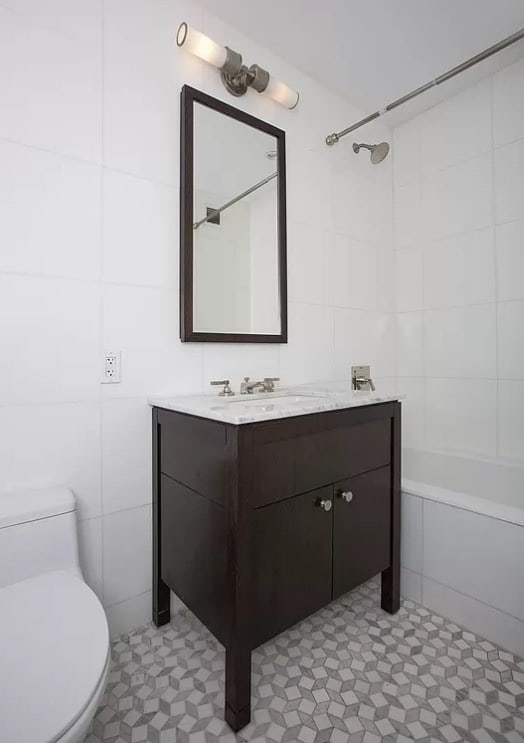 bathroom featuring vanity, tile patterned flooring, toilet, tile walls, and shower / tub combination