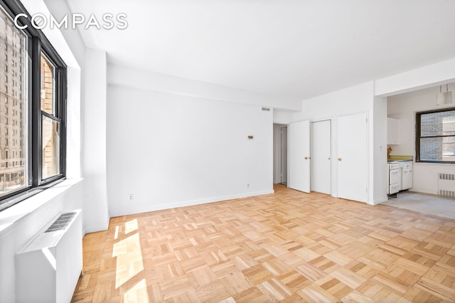interior space with radiator, baseboards, and visible vents