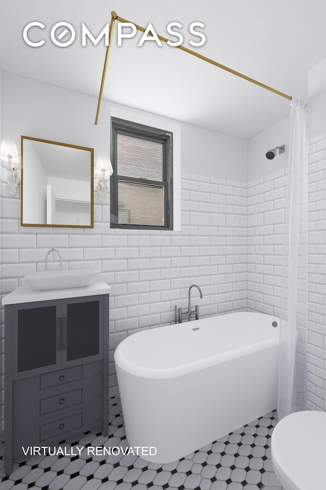 7 Park Ave Unit 66, New York City, NY 10016 - full bathroom featuring tile walls, a freestanding tub, vanity, toilet, and a shower with shower curtain