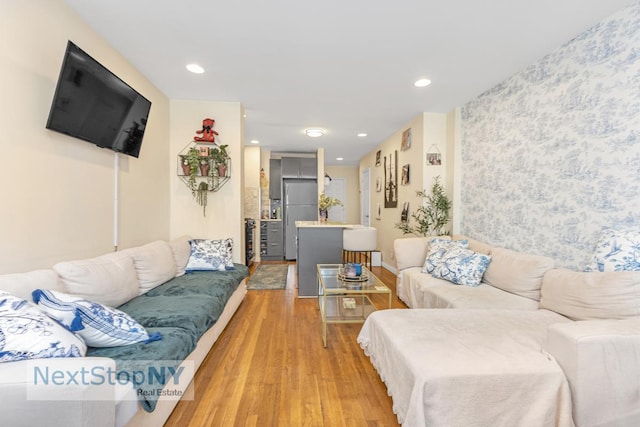 living room with recessed lighting and light wood-style flooring