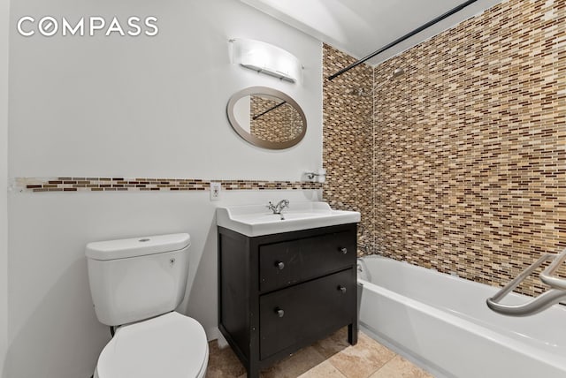 full bath with toilet, vanity, tile walls, and  shower combination