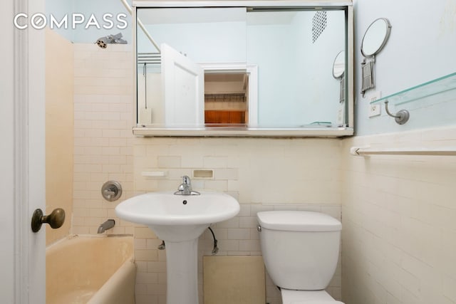 20 W 72nd St Unit 1403, New York City, NY 10023 - bathroom featuring tile walls, toilet, and tub / shower combination