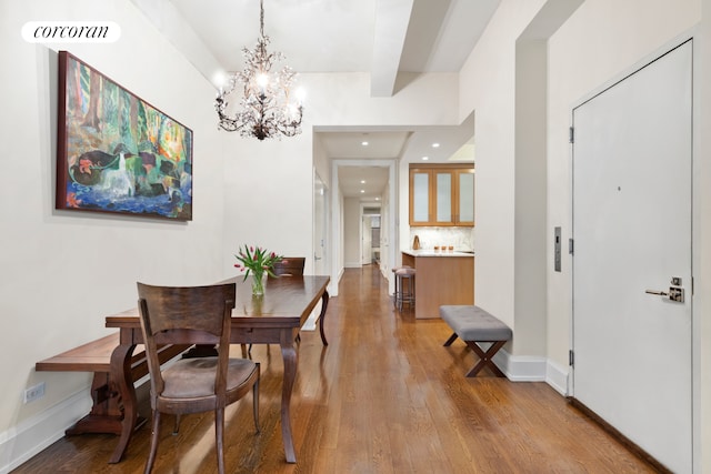 dining area with visible vents, wood finished floors, baseboards, recessed lighting, and a notable chandelier