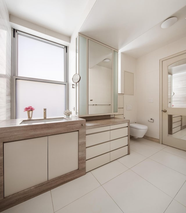 71 Park Ave Unit 10-A, New York City, NY 10016 - bathroom featuring vanity, toilet, and tile patterned flooring