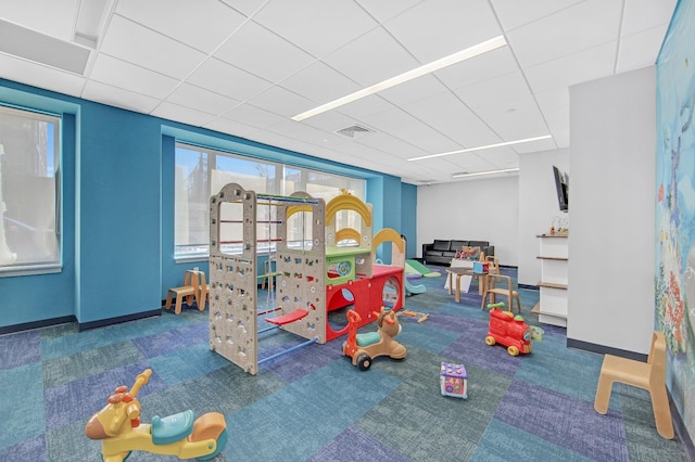 425 Main St Unit 4-C, New York City, NY 10044 - rec room featuring carpet, a paneled ceiling, and baseboards