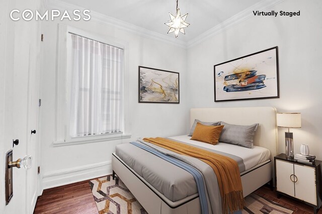bedroom featuring crown molding, baseboards, and dark wood-style floors