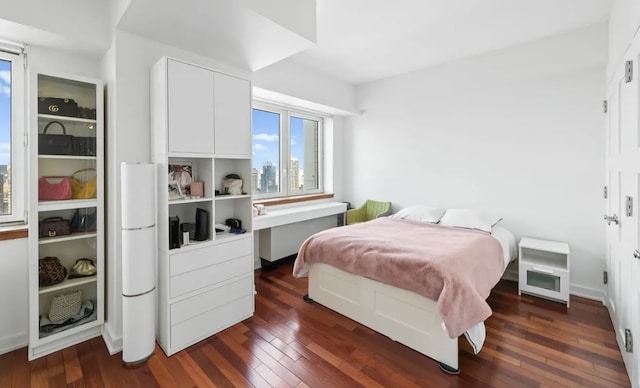 bedroom with dark wood finished floors
