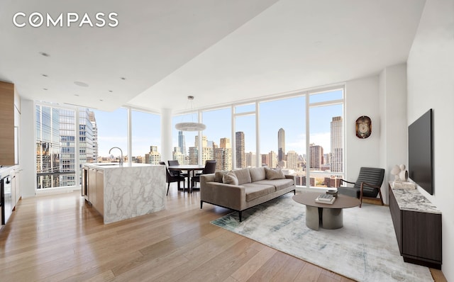30 Riverside Blvd Unit 33D, New York City, NY 10069 - living room with light wood-style floors, floor to ceiling windows, and healthy amount of natural light