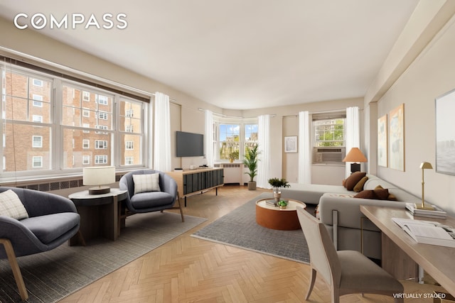 living area featuring radiator heating unit and cooling unit
